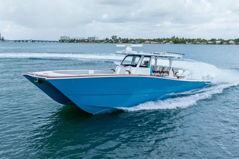 Slide: The Image of 2024 Freeman 47 boat cruising on open water, showcasing sleek blue design. - 7