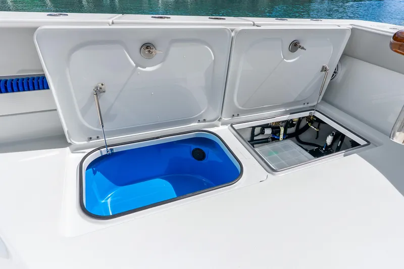 Slide: The Image of Open storage compartments on a 2024 Freeman 47 boat, featuring a blue interior. - 70