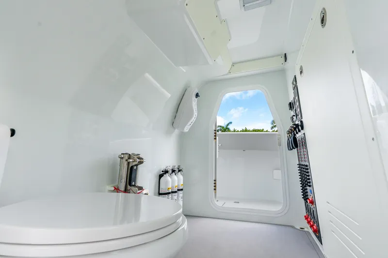Slide: The Image of Interior of a 2024 Freeman 47 boat, featuring a modern bathroom and control panel. - 72