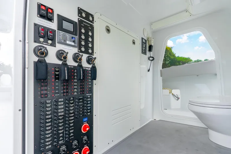 Slide: The Image of Control panel and toilet inside a 2024 Freeman 47 boat cabin, featuring modern equipment. - 75