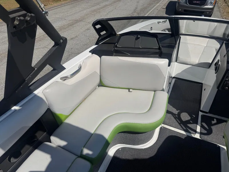 Slide: The Image of Interior of a 2016 Axis T22 boat with white and green seating. - 10