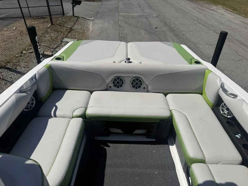 Slide: The Image of Interior of a 2016 Axis T22 boat with green and white seating. - 11