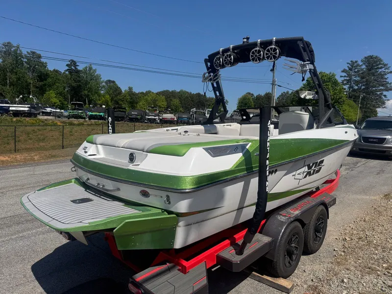 Slide: The Image of 2016 Axis T22 boat on red trailer, green and white design. - 3