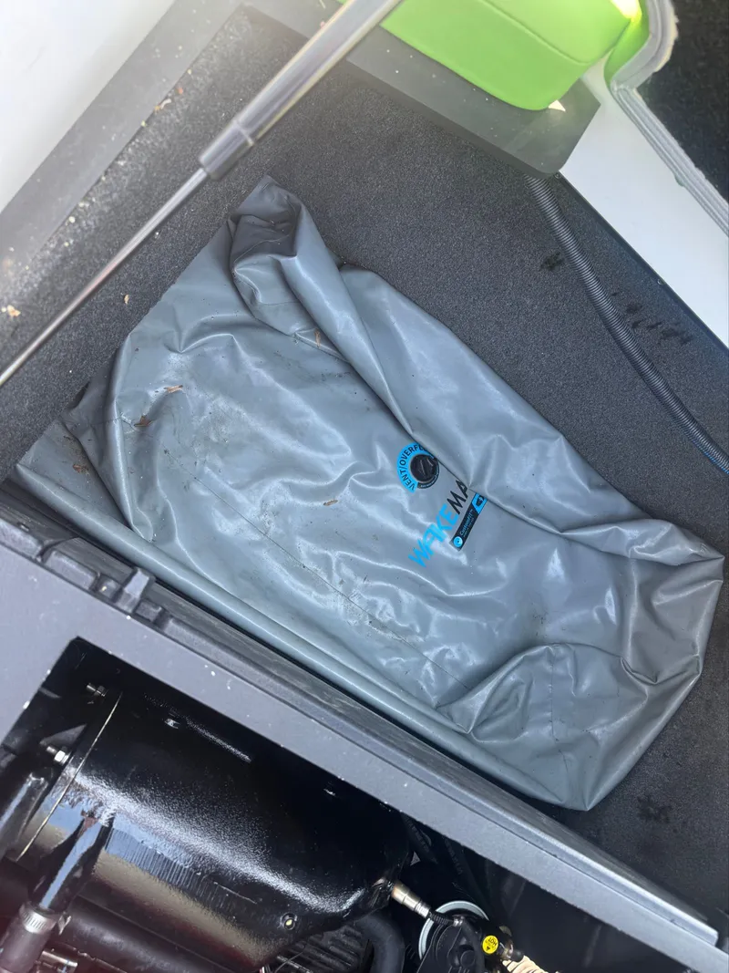 Slide: The Image of Axis T22 2016 boat with gray water bag in storage compartment. - 6