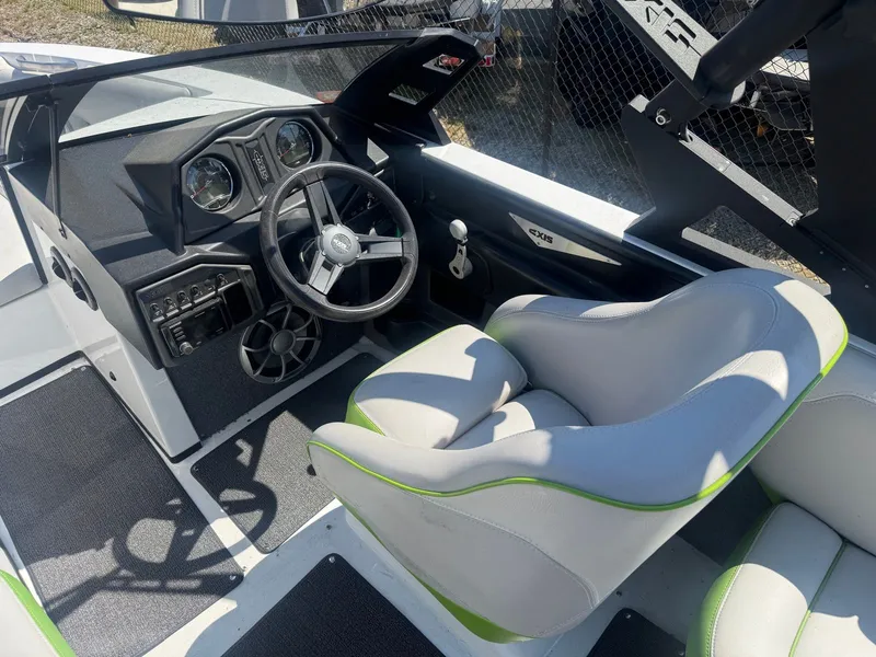 Slide: The Image of Interior of a 2016 Axis T22 boat with steering wheel and seats. - 8