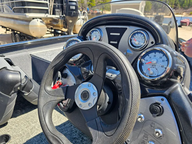 Slide: The Image of Steering wheel and dashboard of a 2025 Tracker Proteam 175 boat. - 10