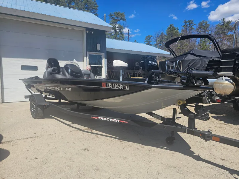 Slide: The Image of 2025 Tracker Proteam 175 boat parked outside garage. - 3