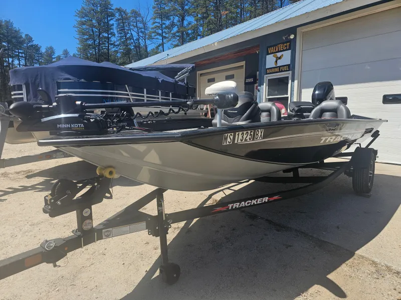 Slide: The Image of 2025 Tracker Proteam 175 boat on trailer in front of garage. - 4