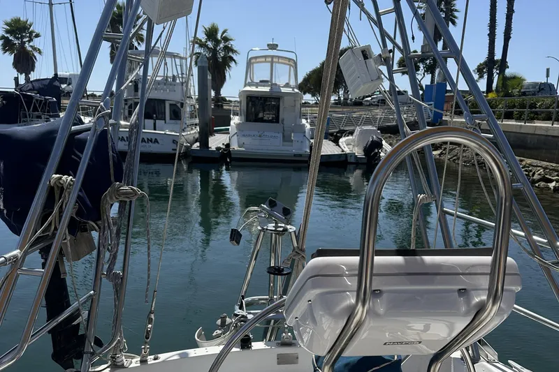 Slide: The Image of Sailboat Catalina 36 MkII, 1989 model, docked in a marina with palm trees. - 11