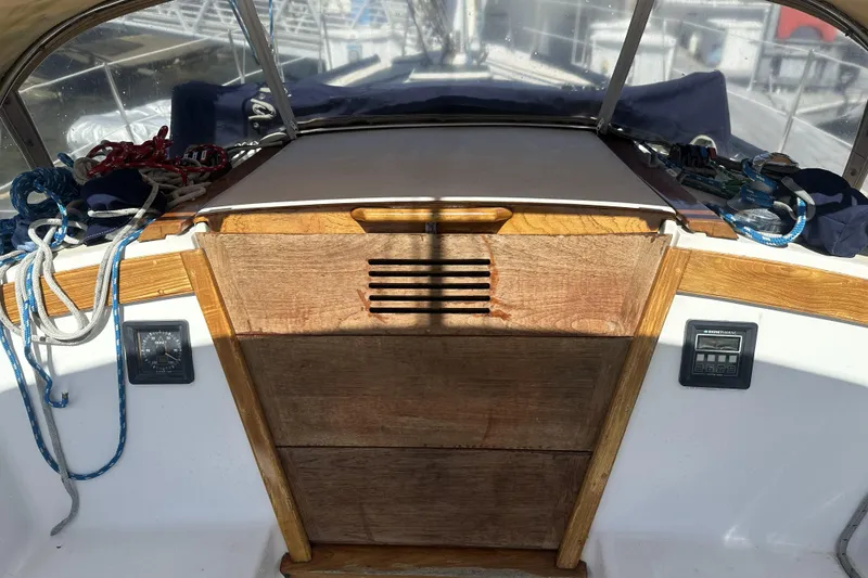 Slide: The Image of Cockpit of 1989 Catalina 36 MkII sailboat with wooden hatch and nautical ropes. - 12