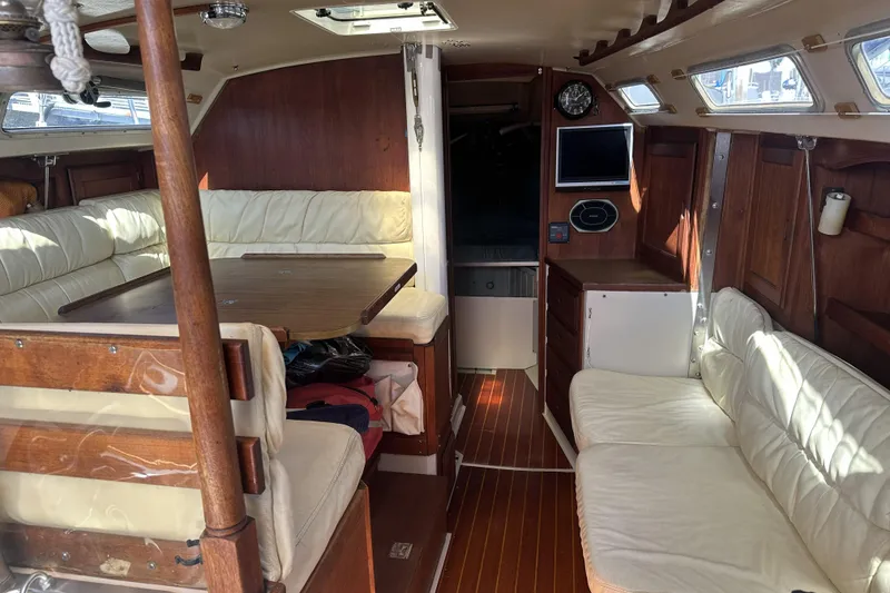 Slide: The Image of Interior of a 1989 Catalina 36 MkII sailboat with wood accents and white seating. - 13