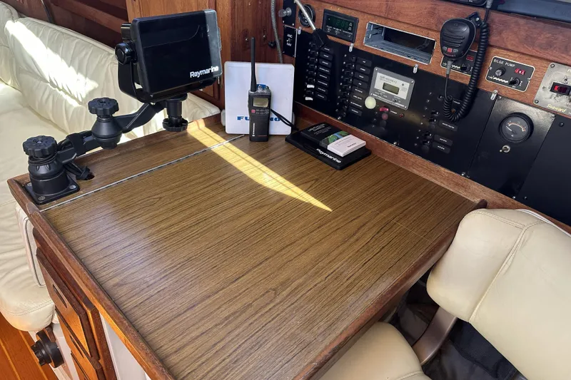 Slide: The Image of Navigation station inside a 1989 Catalina 36 MkII sailboat with electronic equipment and controls. - 14