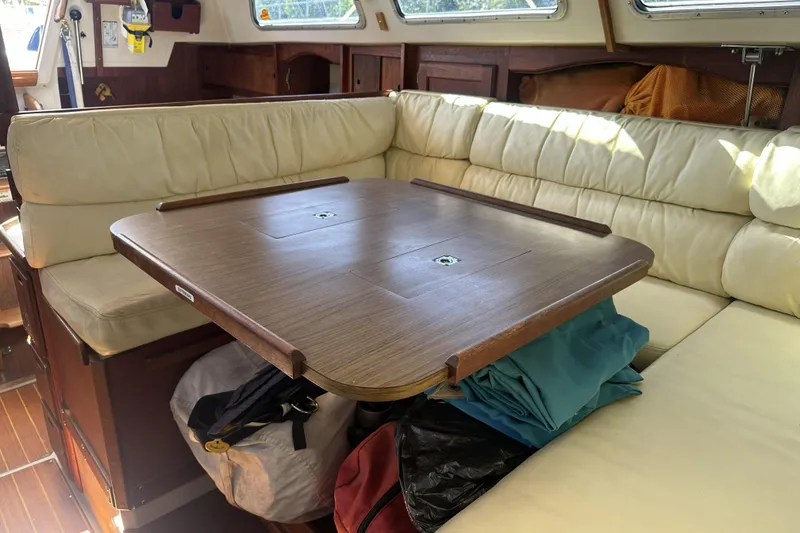 Slide: The Image of Interior of 1989 Catalina 36 MkII sailboat with wooden table and cream seating. - 17