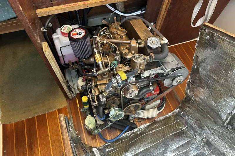 Slide: The Image of Engine compartment of a 1989 Catalina 36 MkII sailboat, showcasing mechanical components. - 21