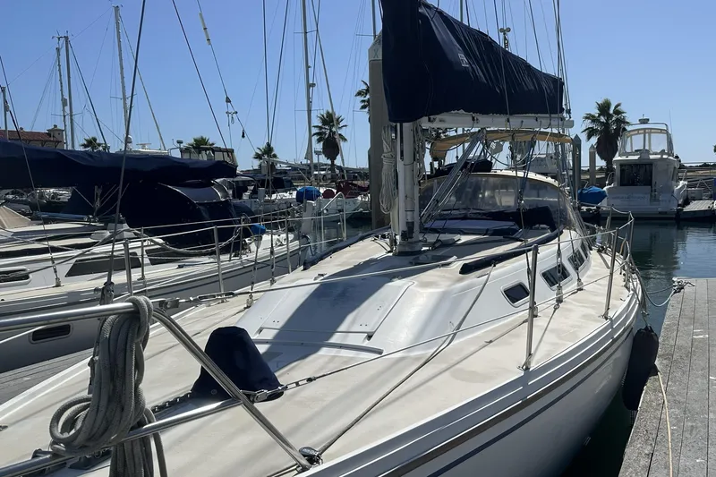 Slide: The Image of 1989 Catalina 36 MkII sailboat docked in a sunny marina. - 3