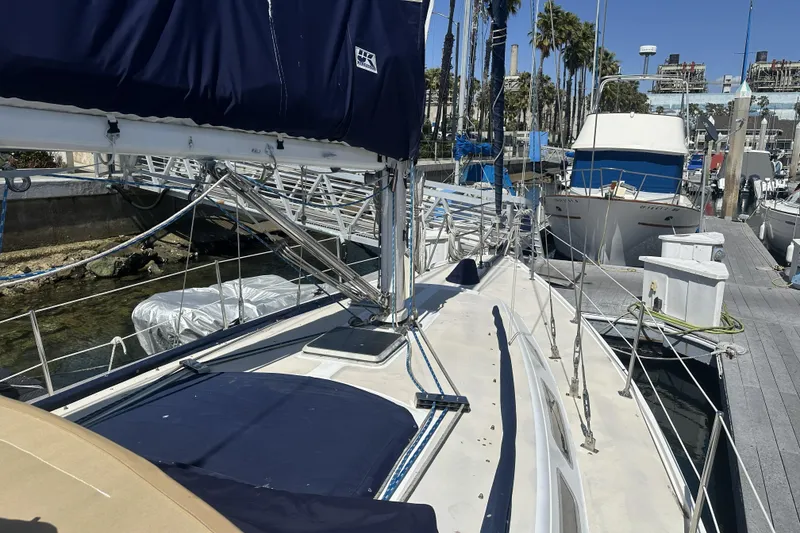 Slide: The Image of 1989 Catalina 36 MkII sailboat docked at marina with blue covers and clear sky. - 4