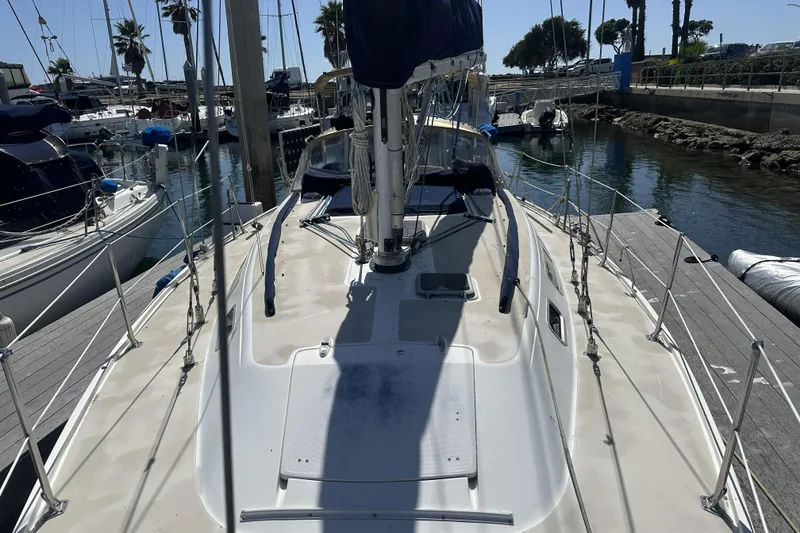 Slide: The Image of 1989 Catalina 36 MkII sailboat docked at a marina, surrounded by other boats. - 5