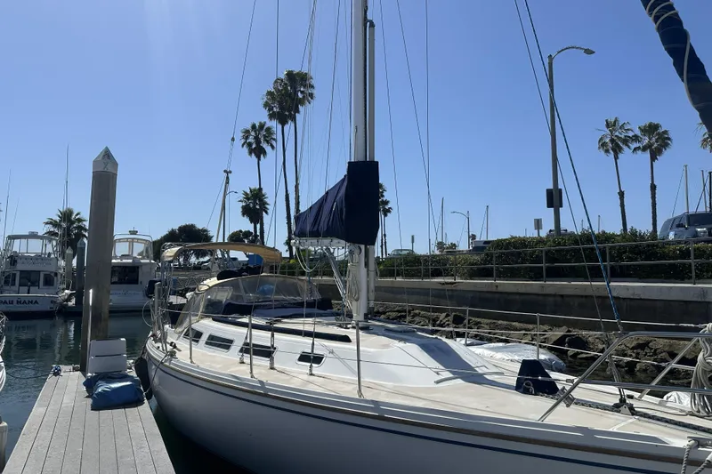 Slide: The Image of Catalina 36 MkII sailboat docked at marina, sunny day, palm trees in background. - 7