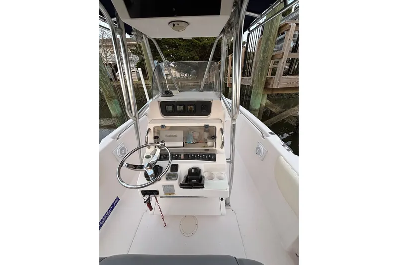Slide: The Image of 2006 Grady-White Advance 257 boat cockpit with steering wheel and control panel. - 8