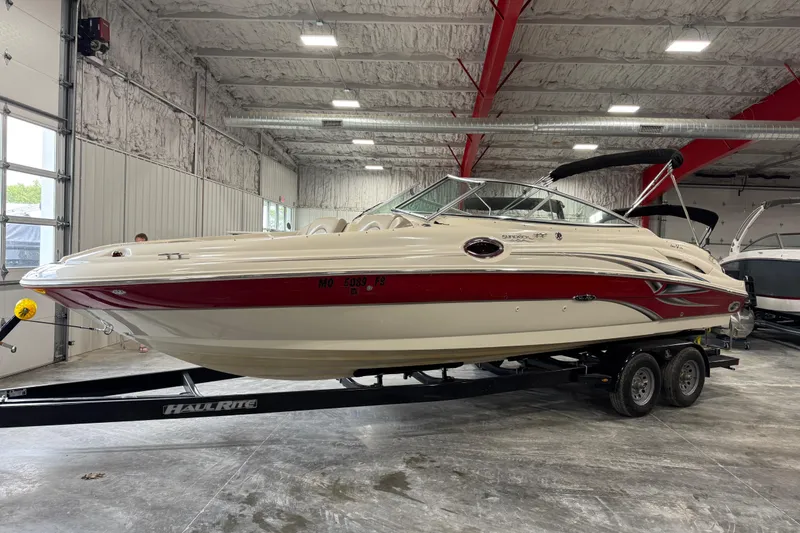 The Image of 2003 Sea Ray 270 Sundeck boat on trailer in indoor storage facility. - 1