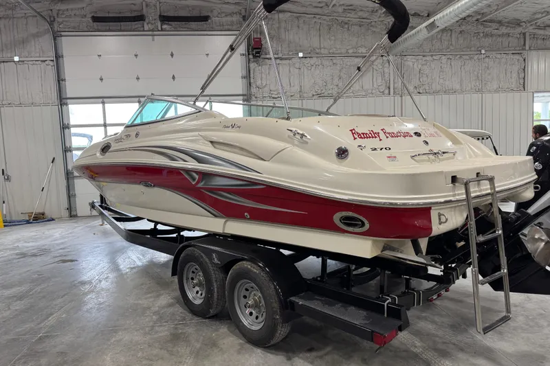 Slide: The Image of 2003 Sea Ray 270 Sundeck boat on trailer in indoor storage facility. - 4