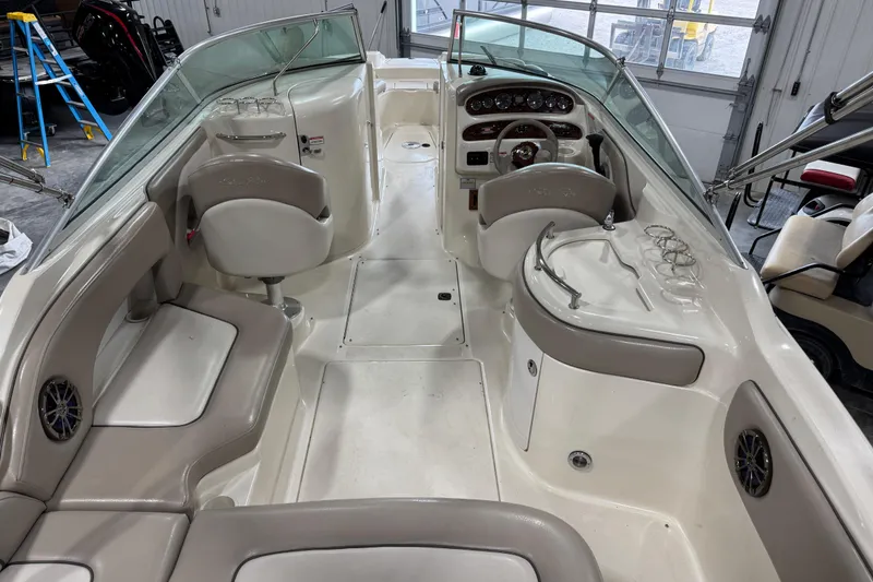 Slide: The Image of Interior view of a 2003 Sea Ray 270 Sundeck boat, featuring seating and dashboard. - 6