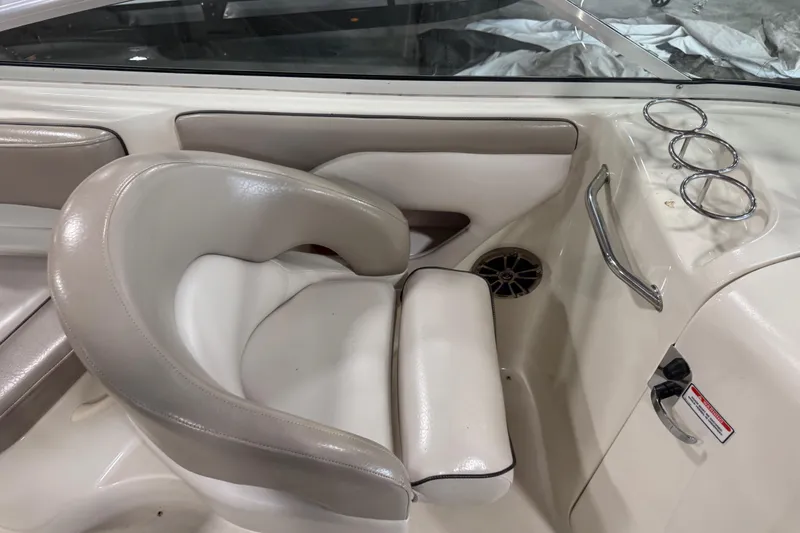 Slide: The Image of 2003 Sea Ray 270 Sundeck interior with beige seating and cup holders. - 8