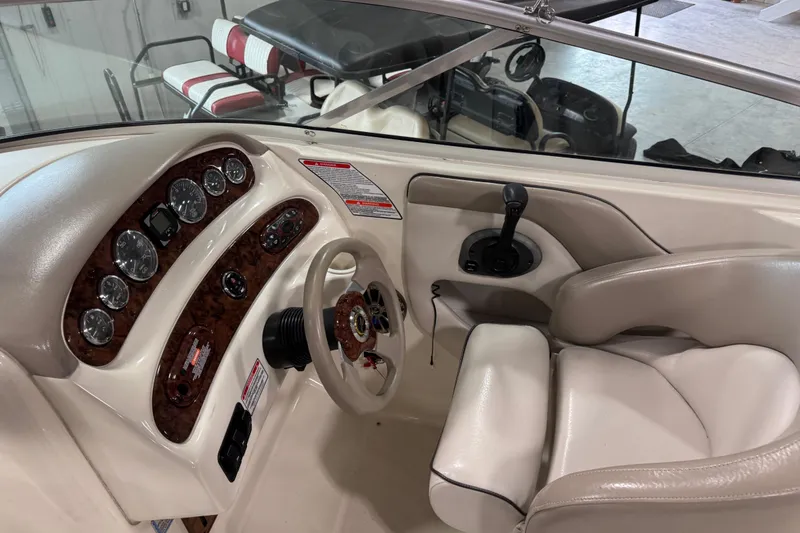 Slide: The Image of 2003 Sea Ray 270 Sundeck boat interior with steering wheel and control panel. - 9