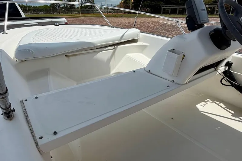 Slide: The Image of 2002 Boston Whaler 130 Sport boat interior with steering console and seating. - 15