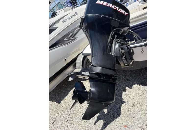 Slide: The Image of Outboard motor on a 2002 Boston Whaler 130 Sport, featuring a Mercury engine. - 16