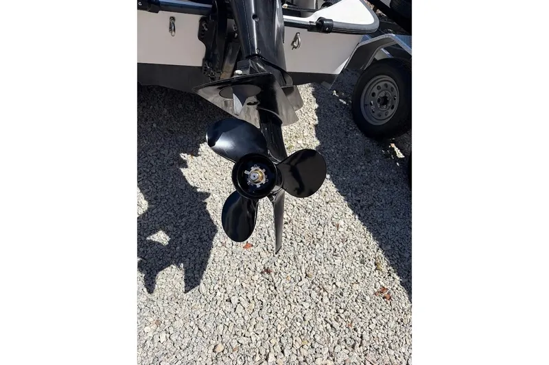 Slide: The Image of Propeller of a 2002 Boston Whaler 130 Sport boat on gravel surface. - 17