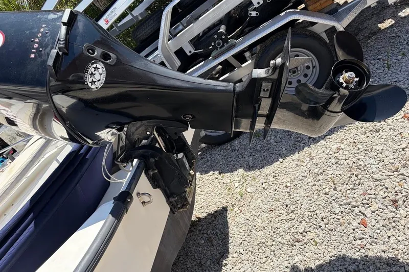 Slide: The Image of Outboard motor of a 2002 Boston Whaler 130 Sport on a trailer. - 18