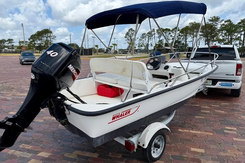 Slide: The Image of 2002 Boston Whaler 130 Sport boat with Mercury 40 engine on trailer. - 3