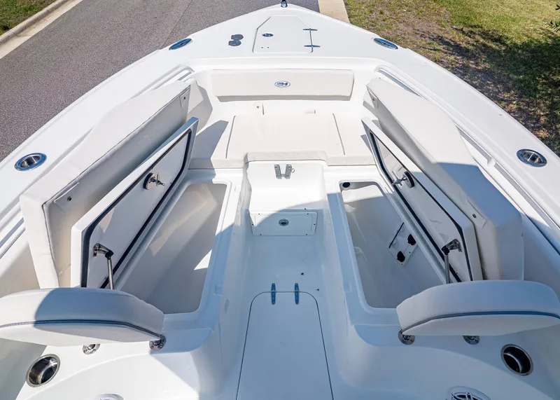 Slide: The Image of Interior view of 2026 Sea Hunt Ultra 265 SE with open storage compartments. - 29