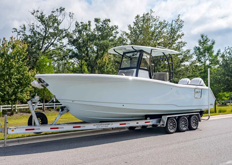 The Image of 2026 Sea Hunt ULTRA 285CB boat on trailer, side view. - 1
