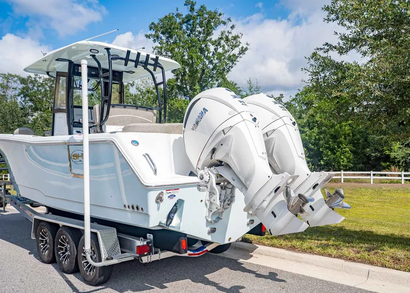 Slide: The Image of Sea Hunt ULTRA 285CB 2026 with dual outboard motors on trailer. - 4