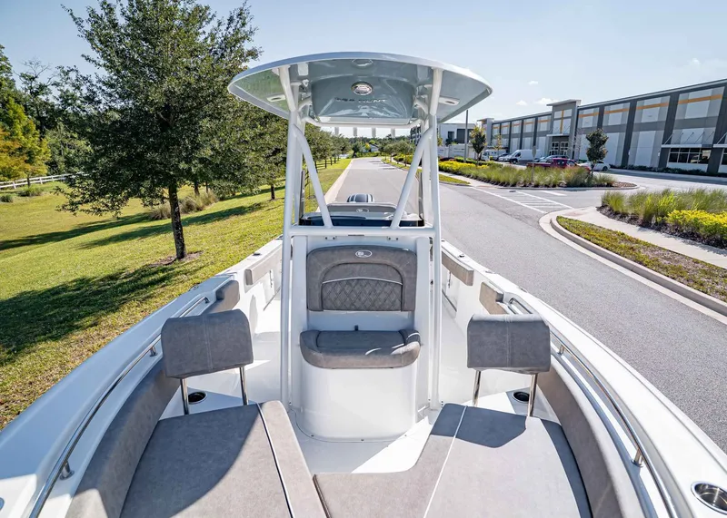 Slide: The Image of 2026 Sea Hunt Ultra 229 boat parked on a road. - 24