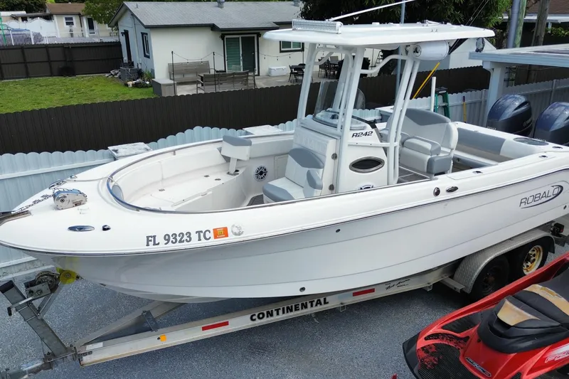 Slide: The Image of 2022 Robalo R242 Center Console boat on trailer in residential driveway. - 10