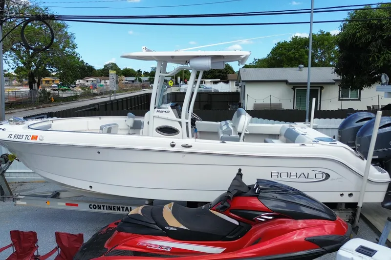 Slide: The Image of 2022 Robalo R242 Center Console boat on trailer, parked outdoors. - 13