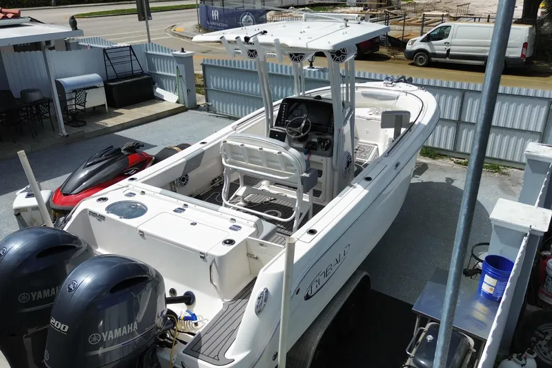 Slide: The Image of 2022 Robalo R242 Center Console boat with Yamaha engines, parked outdoors. - 14