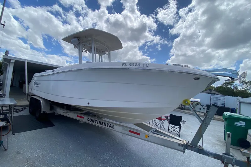 Slide: The Image of 2022 Robalo R242 Center Console boat on trailer under cloudy sky. - 17