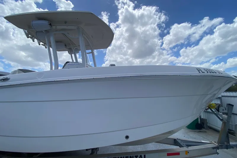 Slide: The Image of 2022 Robalo R242 Center Console boat on trailer under cloudy sky. - 19