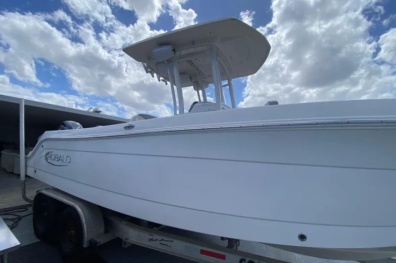 Slide: The Image of 2022 Robalo R242 Center Console boat on trailer under cloudy sky. - 20