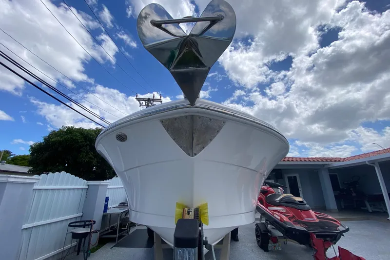 Slide: The Image of 2022 Robalo R242 Center Console boat on trailer under cloudy sky. - 21