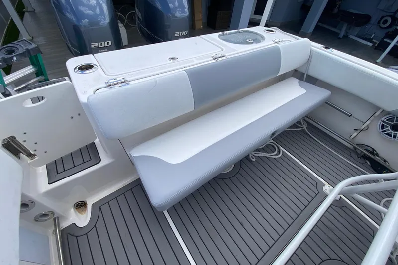 Slide: The Image of 2022 Robalo R242 Center Console boat with cushioned seating and dual Yamaha 200 engines. - 24