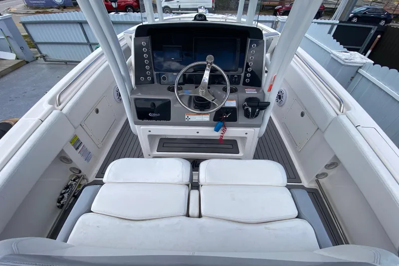 Slide: The Image of 2022 Robalo R242 Center Console boat interior with steering wheel and seating. - 26