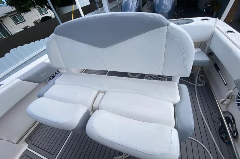 Slide: The Image of 2022 Robalo R242 Center Console boat seating with gray and white upholstery. - 27