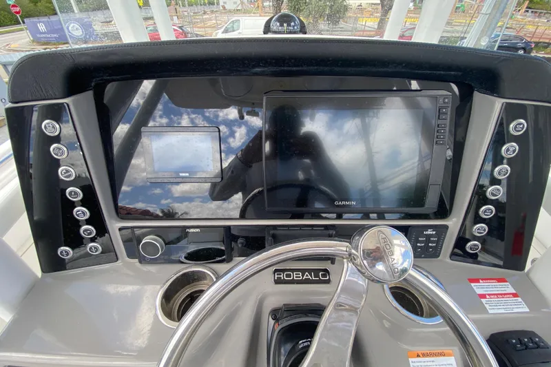 Slide: The Image of 2022 Robalo R242 Center Console dashboard with Garmin display and controls. - 29