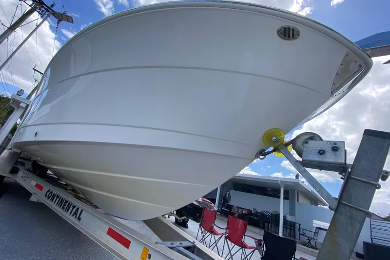 Slide: The Image of 2022 Robalo R242 Center Console boat on trailer, viewed from below. - 3