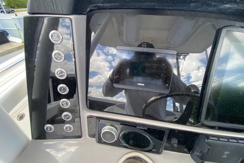 Slide: The Image of 2022 Robalo R242 Center Console dashboard with Yamaha display and control buttons. - 30